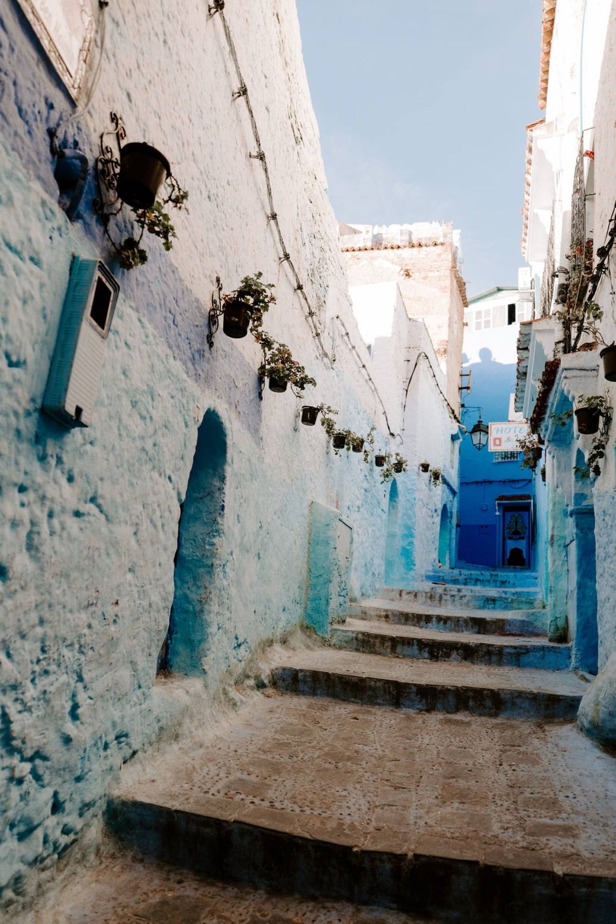 Blue-washed alleyway and stairway in a Moroccan hillside town