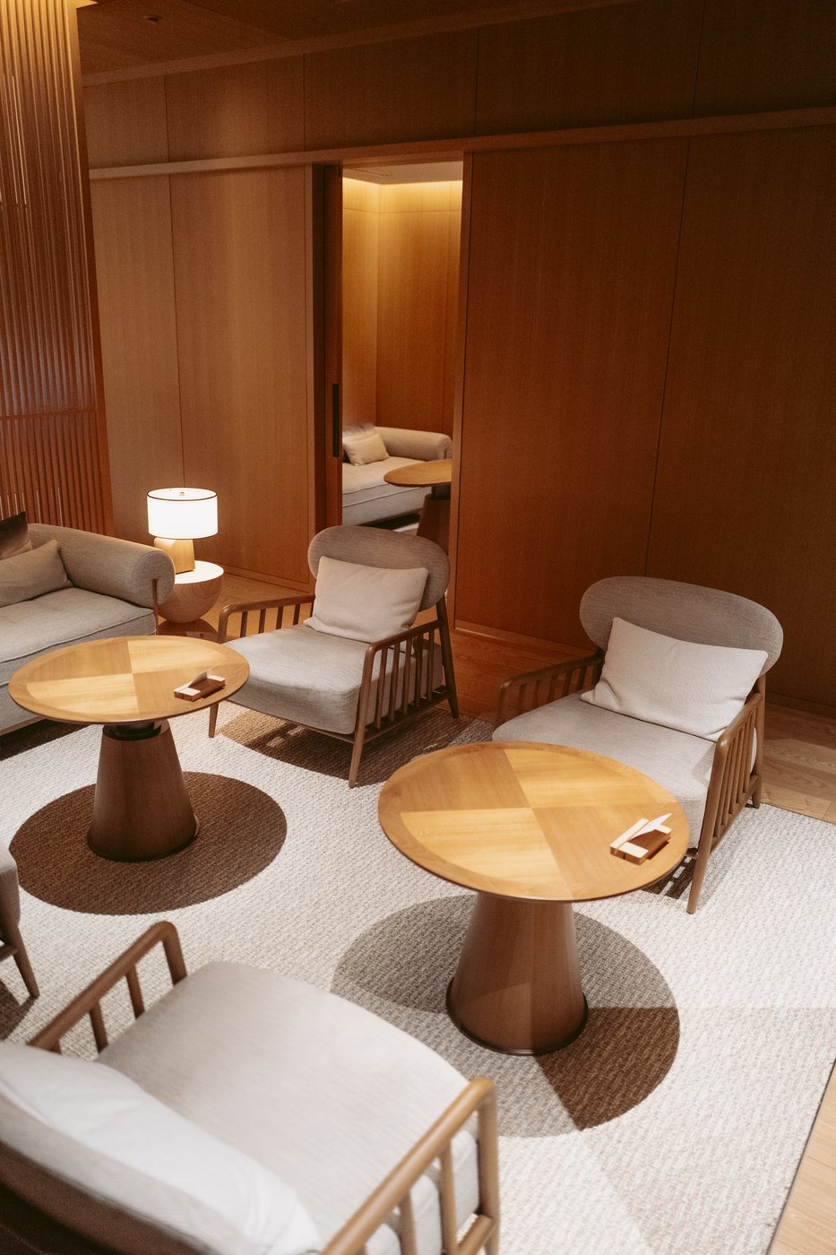 Warm wood-paneled lounge interior at Patina Osaka