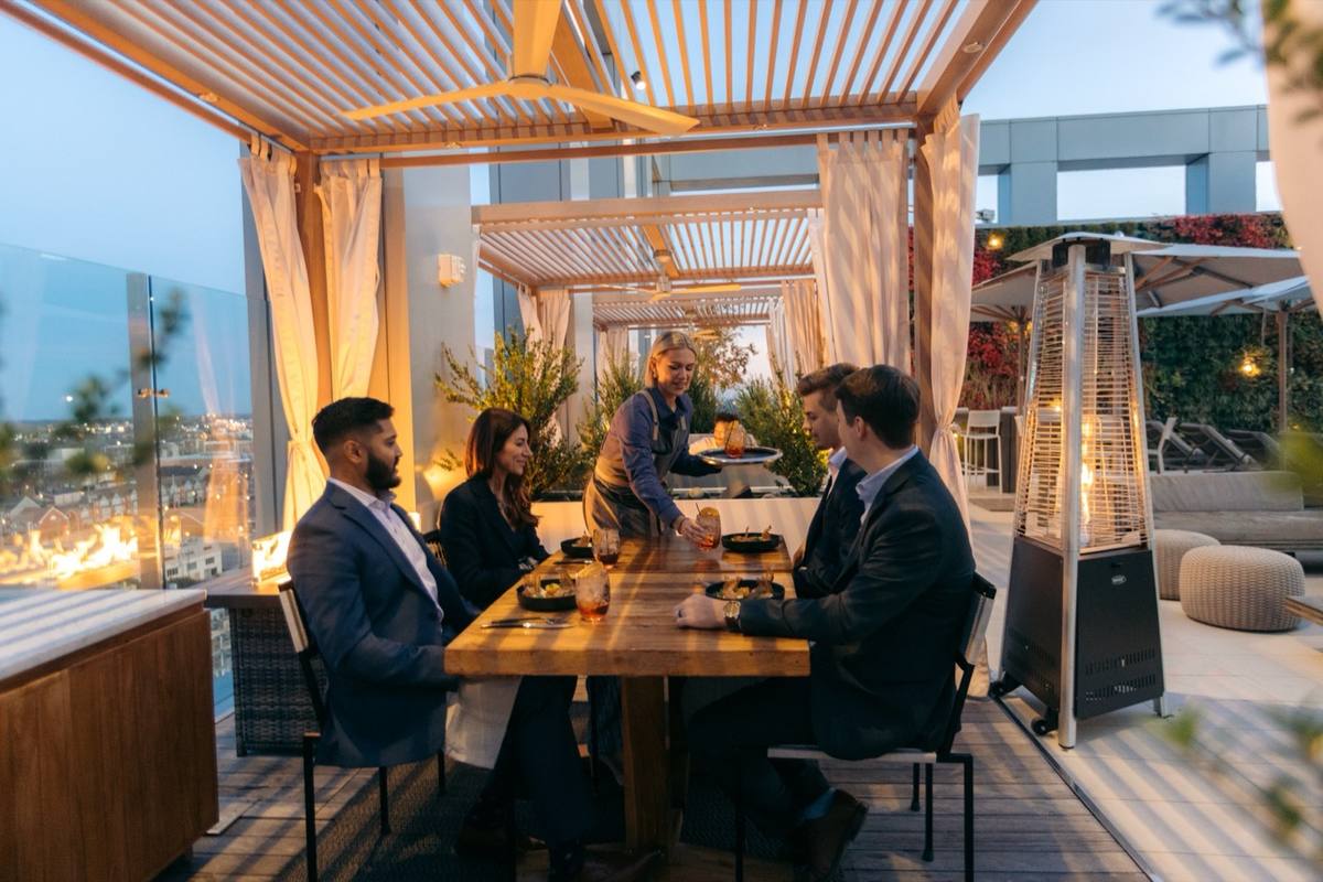 Rooftop dinner group at luxury resort